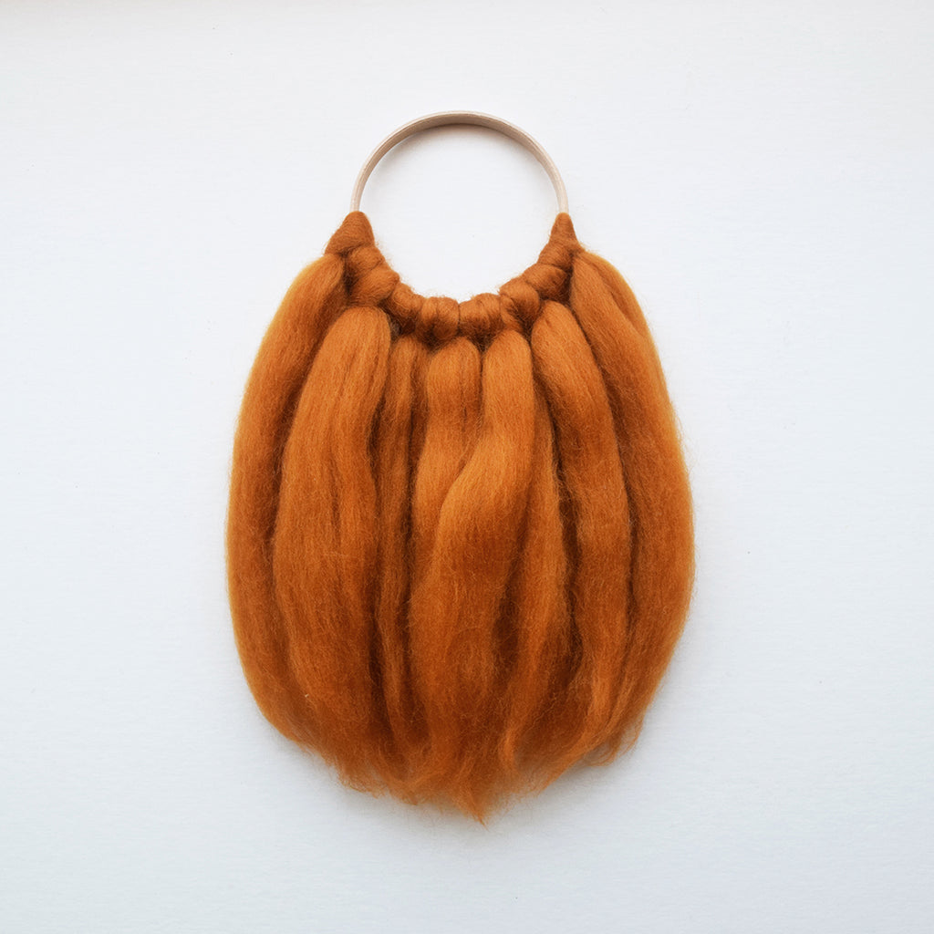 A beautiful handcrafted mini wall hanging on a wooden hoop made from ethically sourced pure merino wool. 