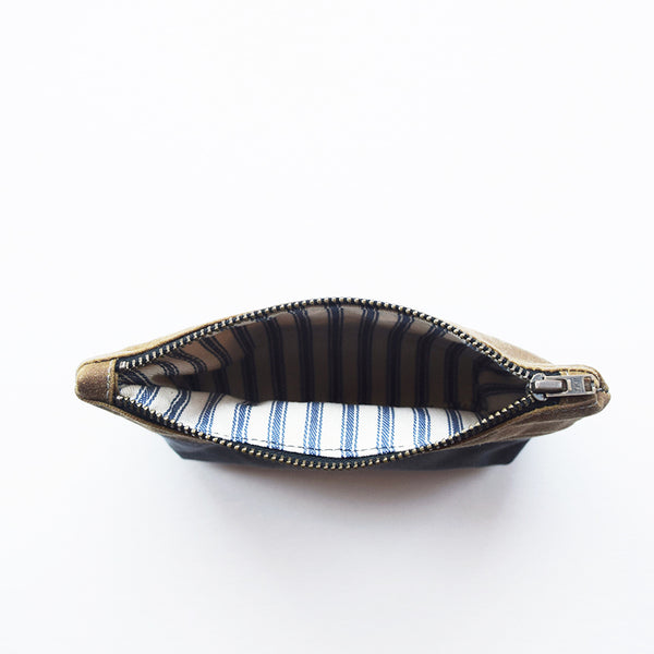 Designed and handcrafted in a seaside studio in Aberdeen, this beautiful and practical pouch is perfect for keeping all your essentials safe when out on your everyday adventures. It's made from waxed cotton canvas which is water resistant and durable.